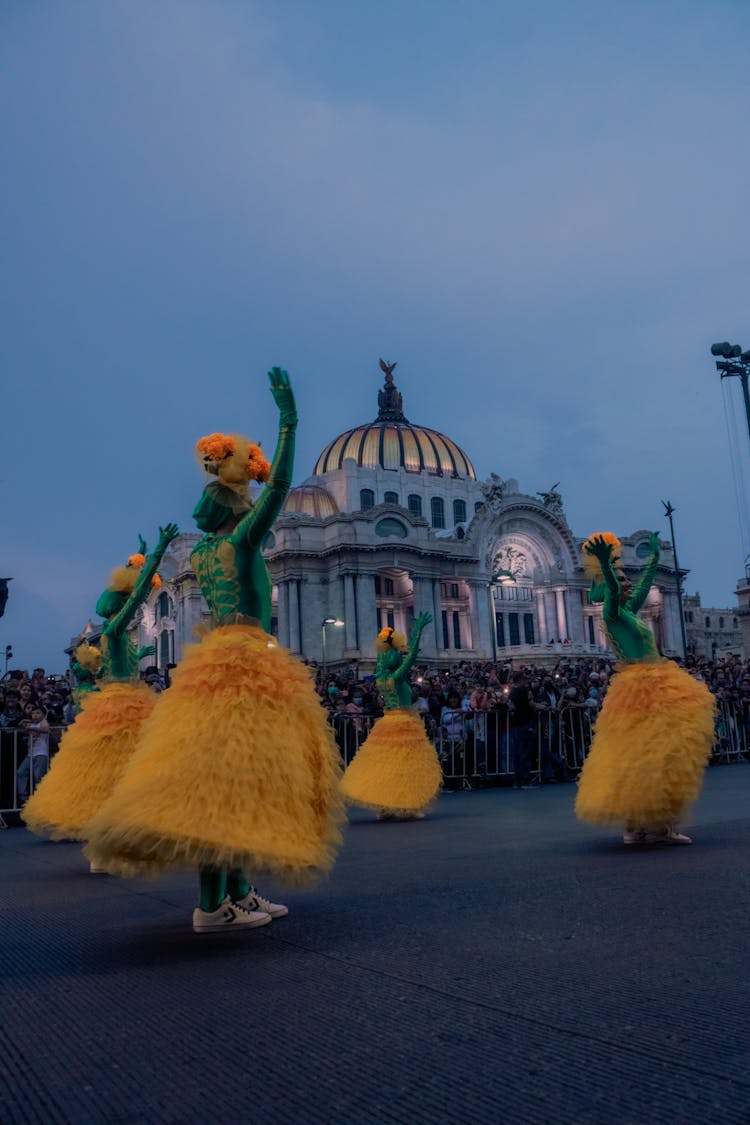 People In Green And Brown Dress Dancing On Street