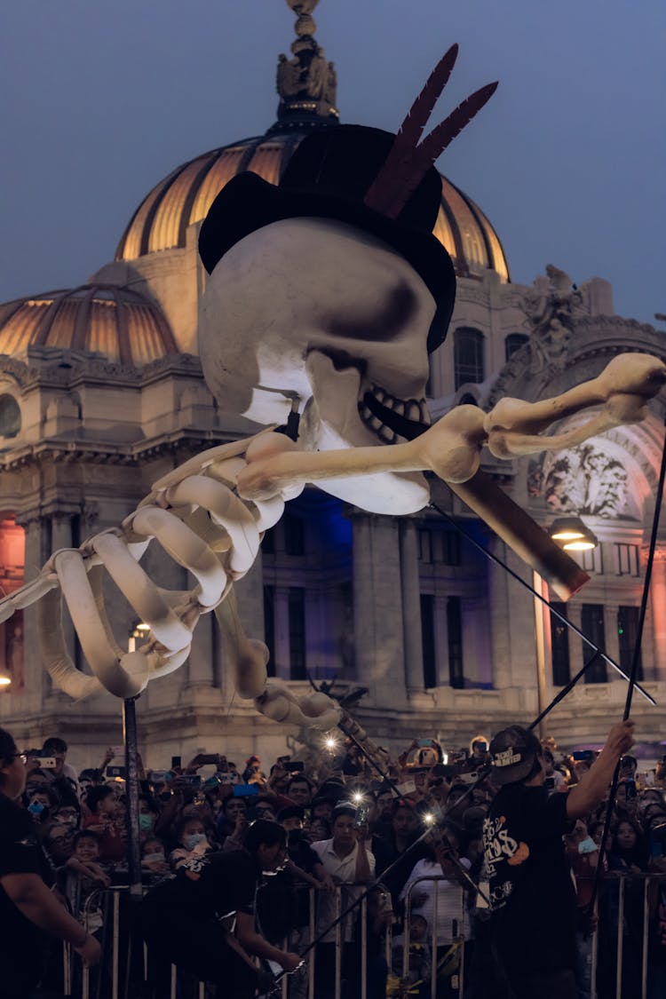 Giant Skeleton Hanging Over Crowd