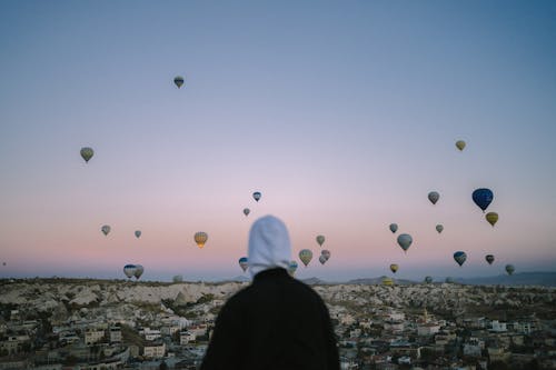 Person Watching Hot Air Balloons Flying Over Cappadocia 