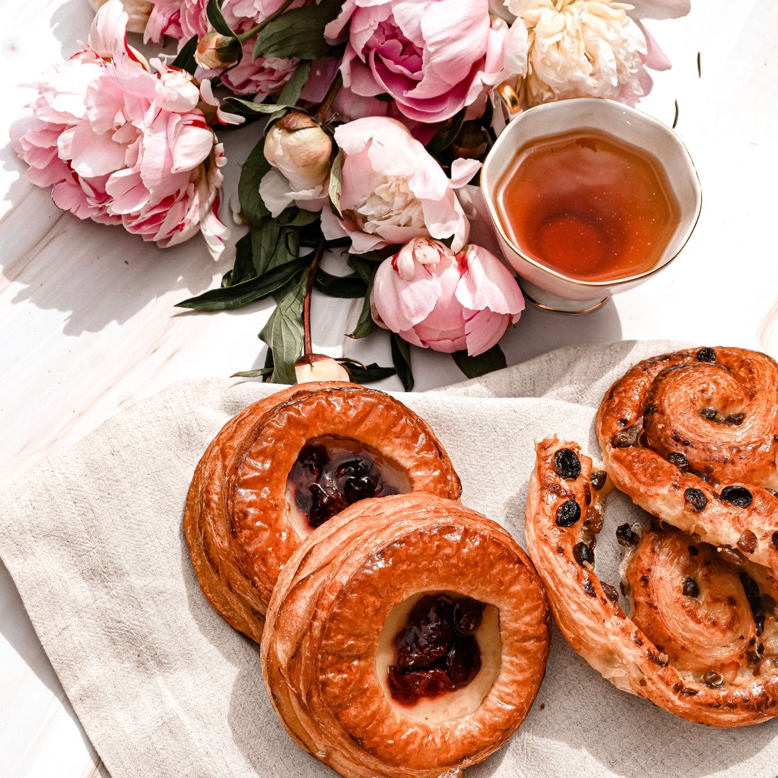 Overhead view of jam pastries and a cup of tea — photo by Studio Naae on Pexels