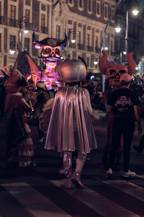 People in Costumes Celebrating on a Street 