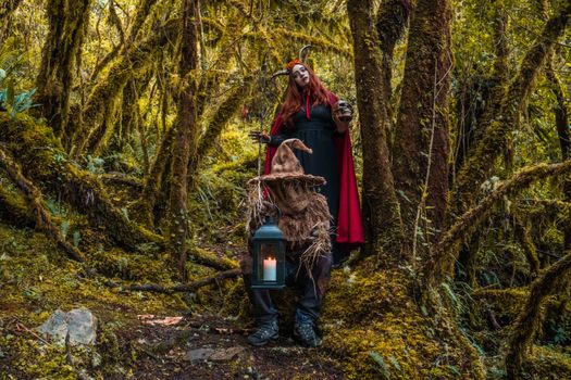 Two People Wearing Halloween Costumes in the Forest
