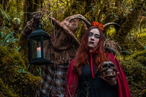 Free Creepy characters in Halloween costumes pose in a dark, mystical forest. Stock Photo