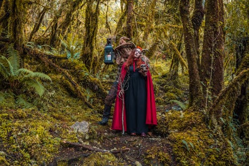 Two People Wearing Halloween Costumes in the Forest