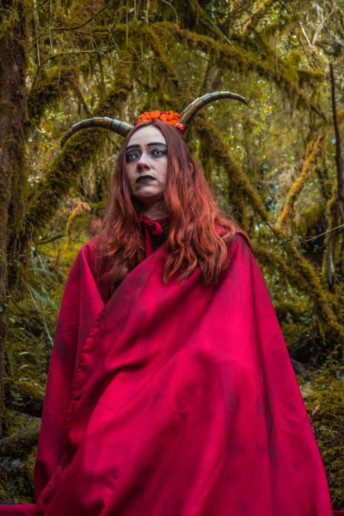 Free A mysterious woman dressed in a witch costume with horns, surrounded by a lush forest in Choachí, Colombia. Stock Photo