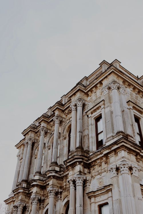 Free Low angle view of a historic stone building showcasing classical architectural features. Stock Photo