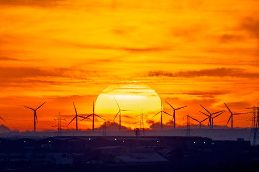 Silhouette of wind turbines at sunset, showcasing sustainable energy solutions.