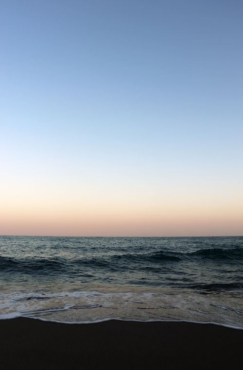 Free Beautiful sunset seascape at Nerja Beach, Andalucia, Spain. Calm waves and pastel sky. Stock Photo