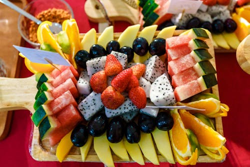 Free Sliced Fruits on Brown Wooden Chopping Board Stock Photo