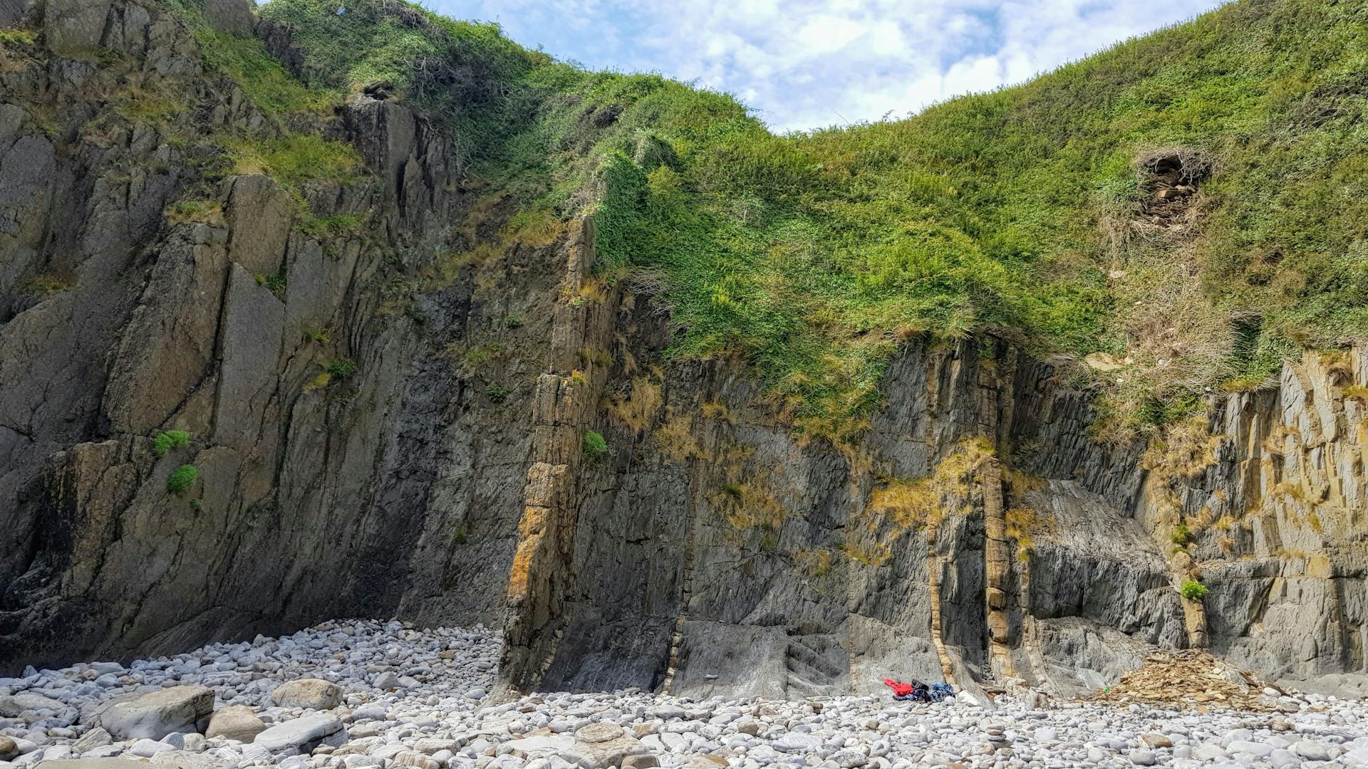 Stunning eroded cliffs at Manorbier Beach, Wales showcasing unique geological formations.