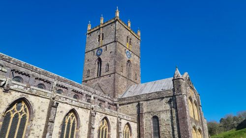 Free Low-angle view of St Davids Cathedral against clear blue sky in Wales. Stock Photo