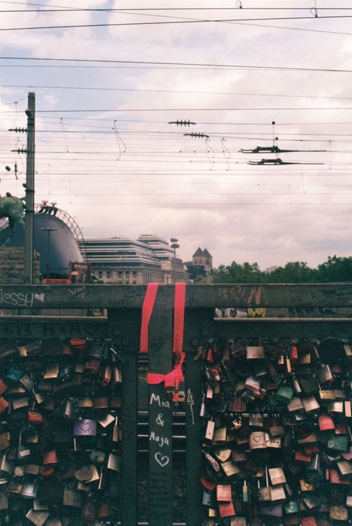Free Collection of love padlocks on Hohenzollern Bridge, Cologne, Germany with train tracks above. Stock Photo