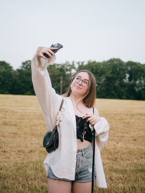 Teenager Taking Selfie in a Mowed Field