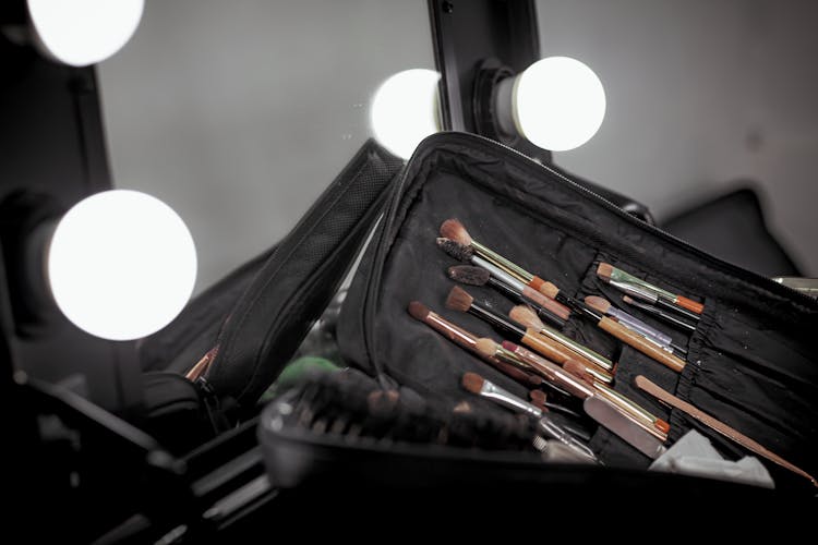  A Set Of Makeup Brushes In A Black Pouch