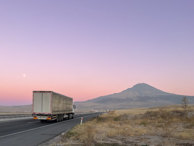 A Truck On The Road Near The Mountain