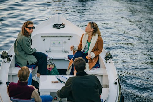 People Riding a Boat in the Canal