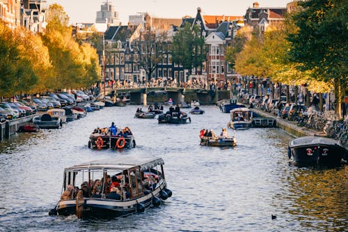 People riding Boats on a Water Canal 