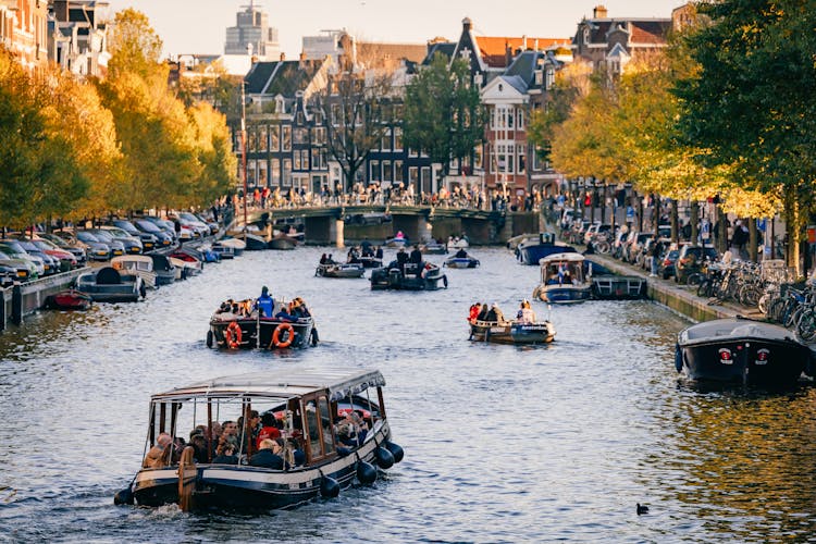 People Riding Boats On A Water Canal 