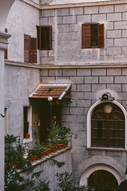 A beautiful architectural facade featuring rustic shutters and potted plants in Istanbul, Turkey.