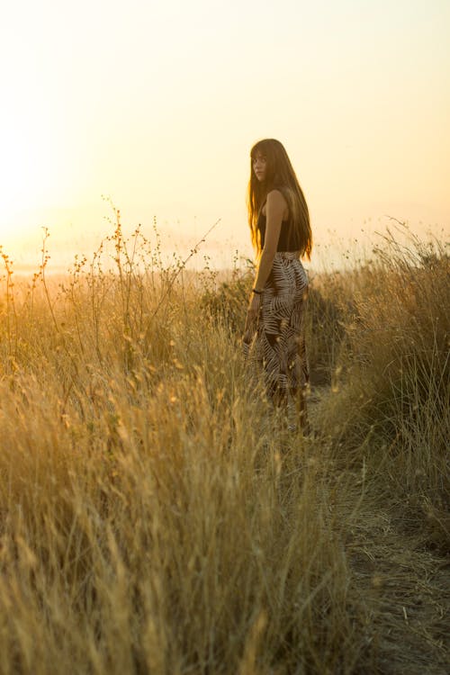 A Long Haired Woman in Black Tank Top Looking Back 