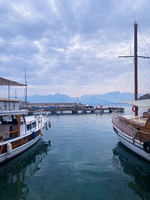 View of Boats Moored in a Port and Mountains in the Background