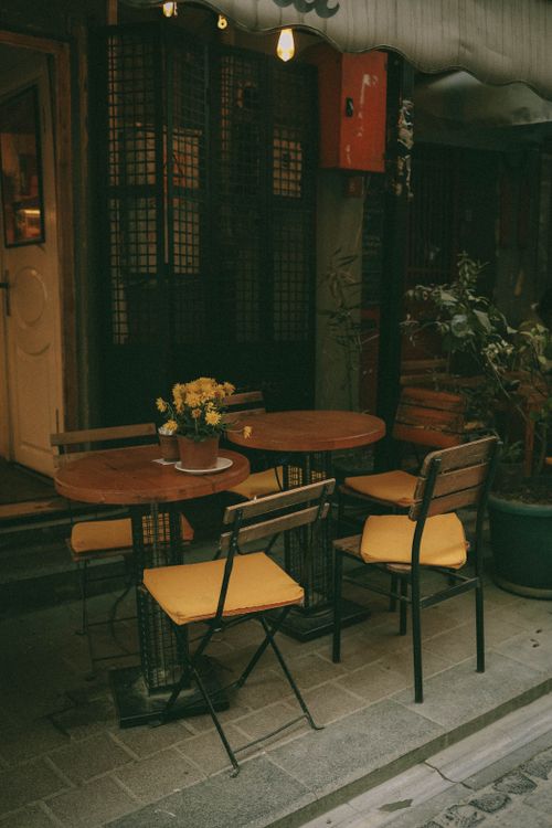 Free Charming outdoor café setting with wooden tables and chairs in Istanbul, Turkey. Stock Photo
