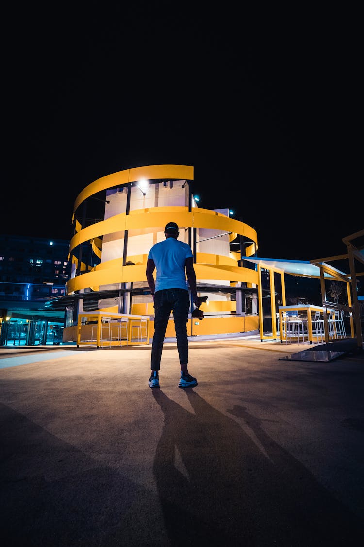 Man Standing Near Building At Night