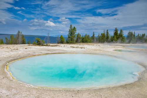 Free Explore the vibrant hot springs at Yellowstone National Park with clear blue water and natural surroundings. Stock Photo