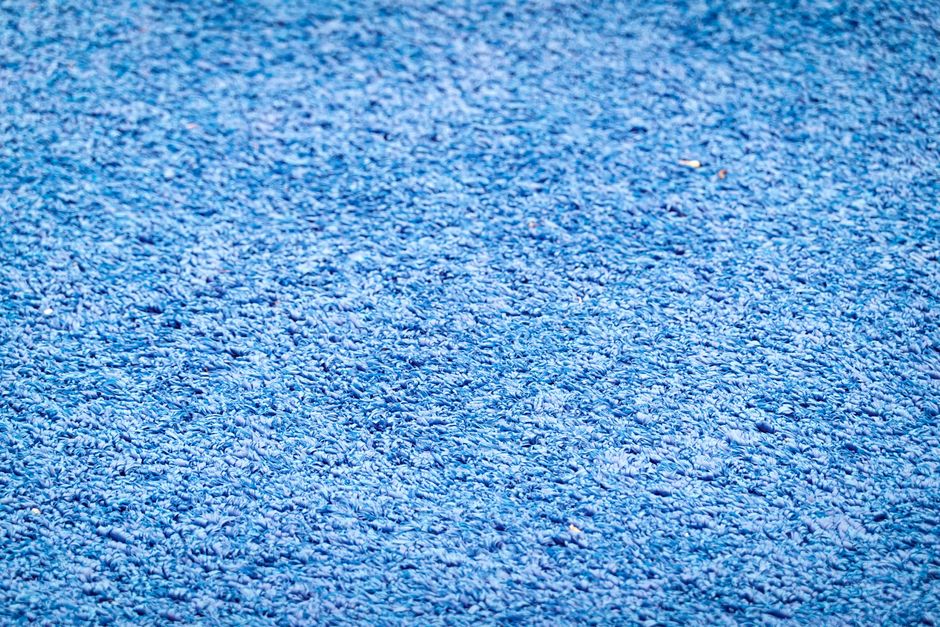 Detailed blue textured fabric surface providing ample copy space for designs or text overlays.