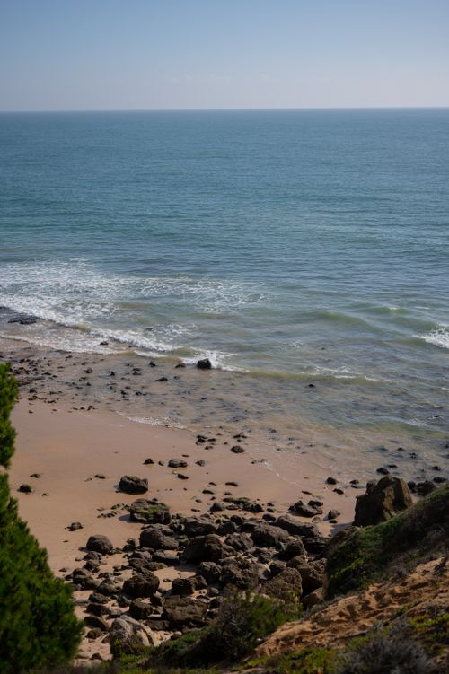 Free High-angle view of a rocky beach in Albufeira, Portugal, showcasing the serene ocean. Stock Photo