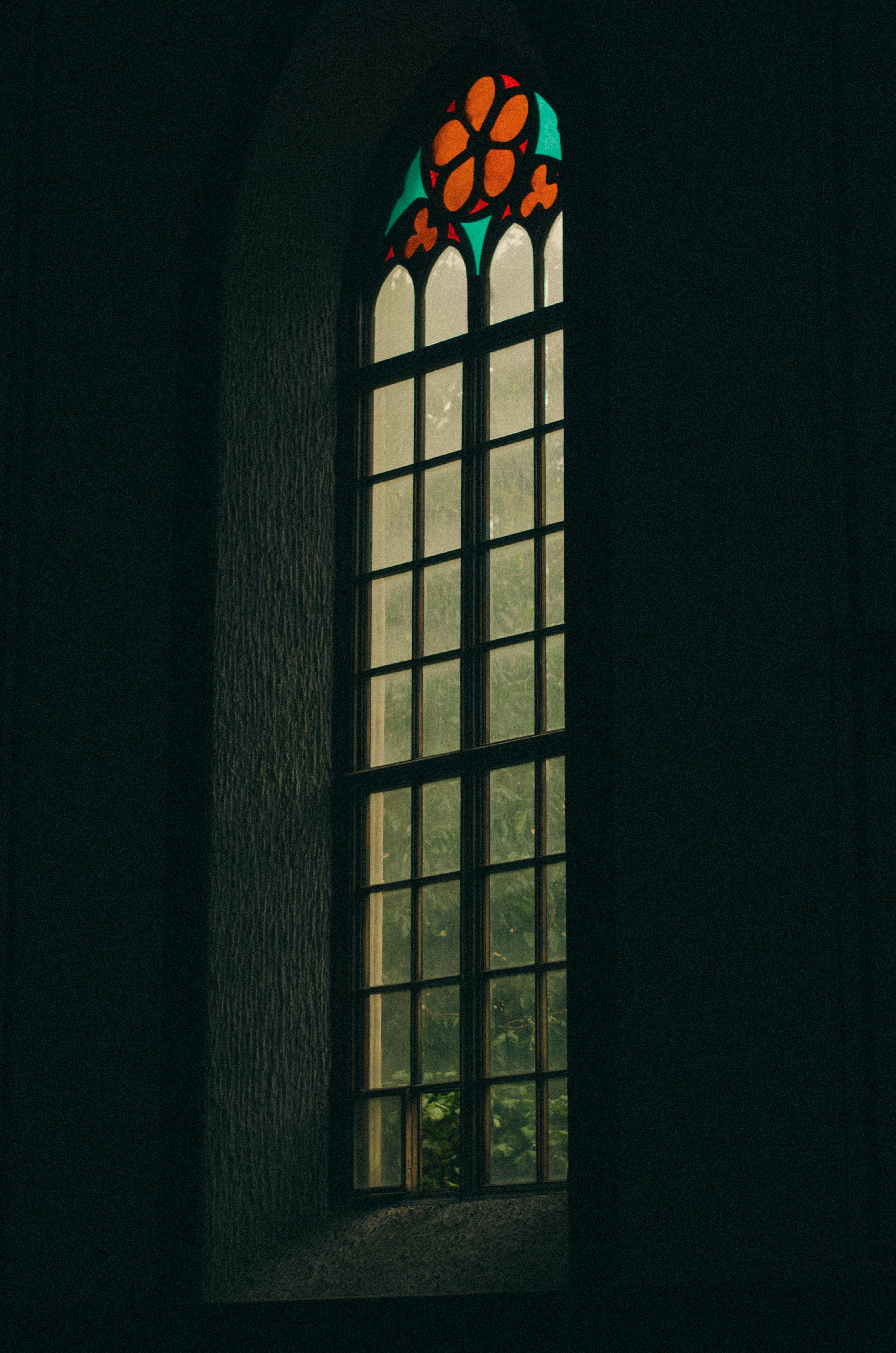 Moody gothic-style stained glass window in Baku, Azerbaijan, casting a serene light.