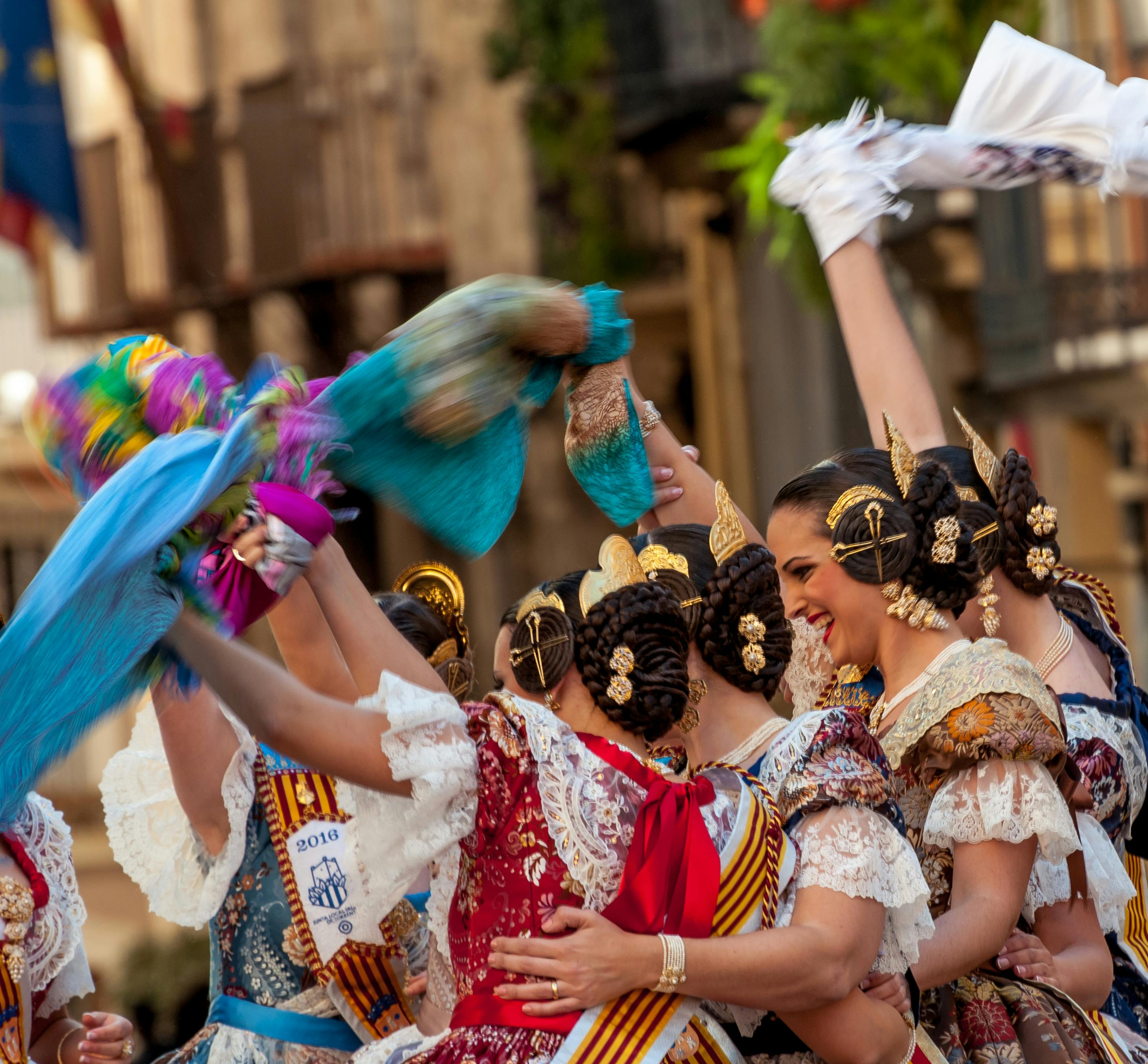 Free Women in traditional Spanish attire celebrate a cultural festival in Valencia with vibrant dances and festive spirit. Stock Photo