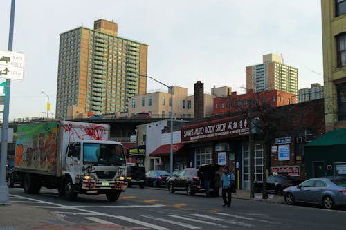 Cars Parked in Front of Brown Concrete Building