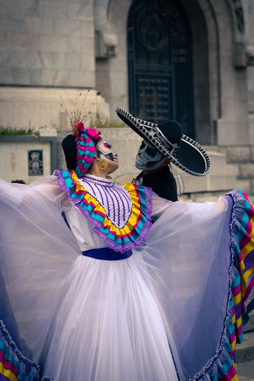 Woman and Man Wearing Dia De Los Muertos Costume