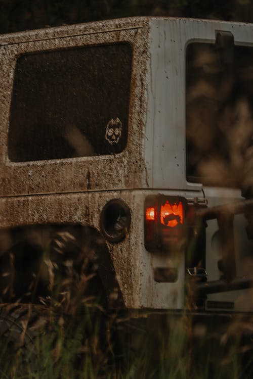 Dirty Gray Vehicle with Illuminated Taillight