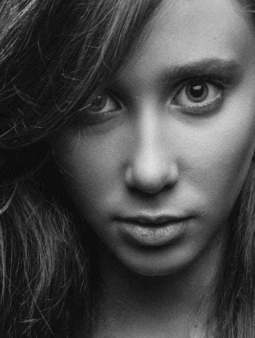 A Grayscale Photo of a Woman Looking with a Serious Face