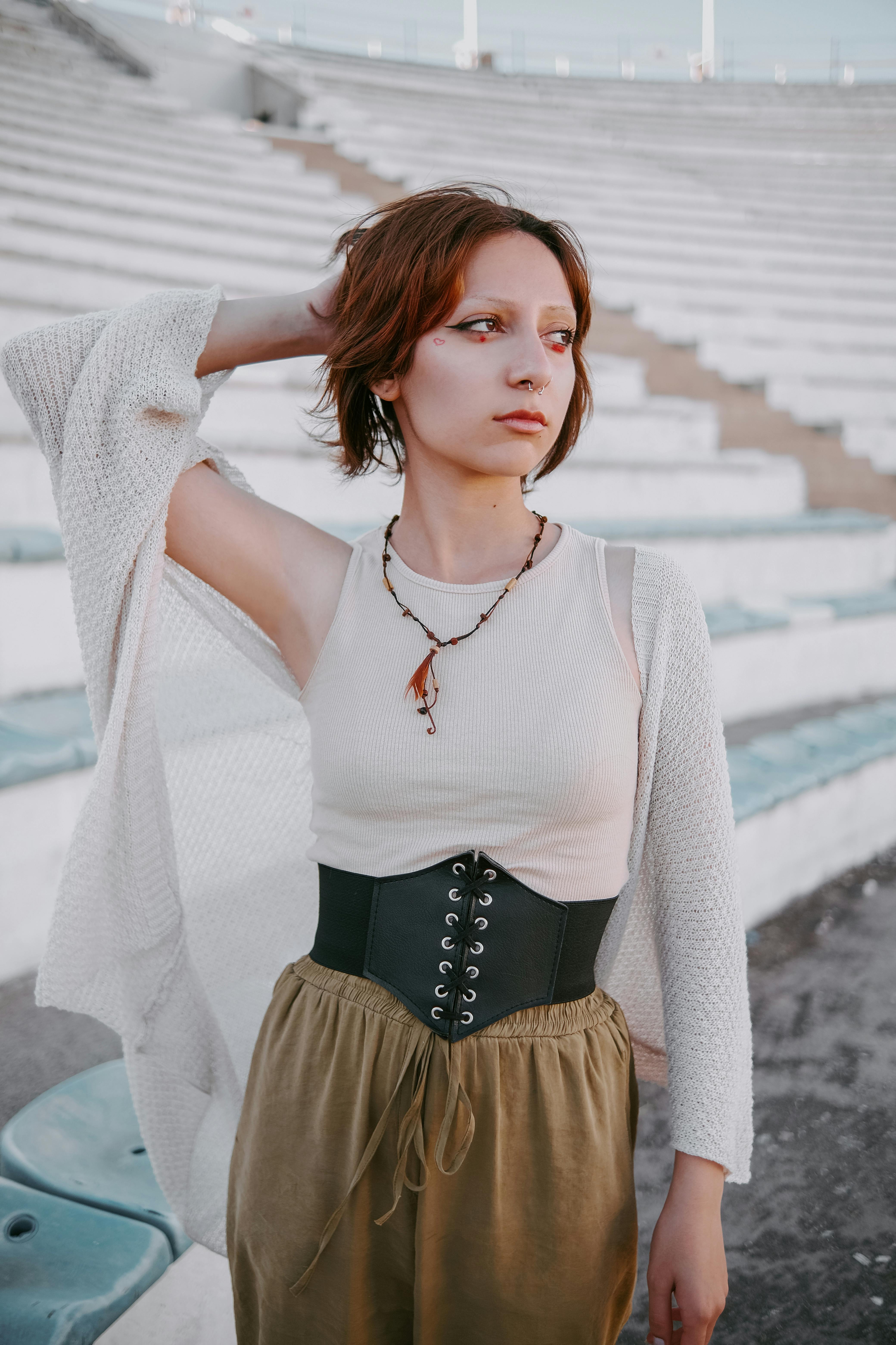 Free Stylish woman posing outdoors in an amphitheater setting, showcasing modern fashion. Stock Photo