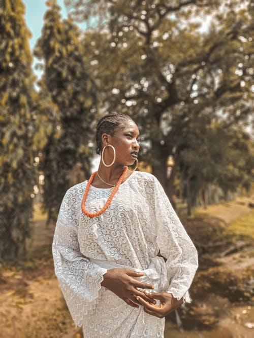 A Woman in White Long Sleeves Dress Looking Over Shoulder