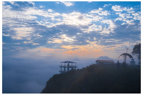 Mountain Peak in Clouds at Sunrise