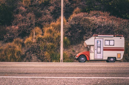 A Red and White Campervan on Road