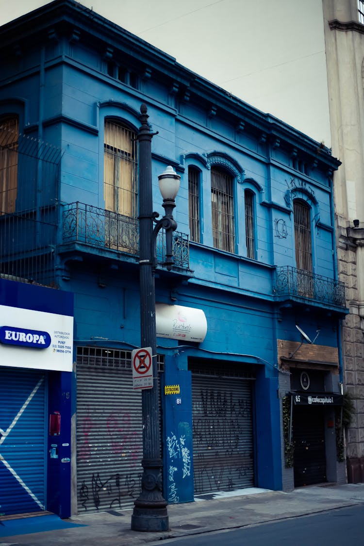 Blue Building With Signage And Roller Shutter Doors