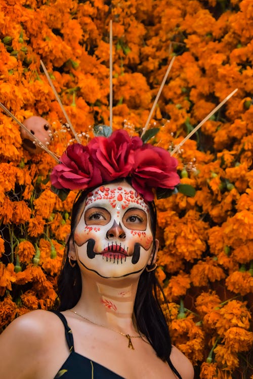 Woman Wearing a Floral Headdress with Skull Face Paint