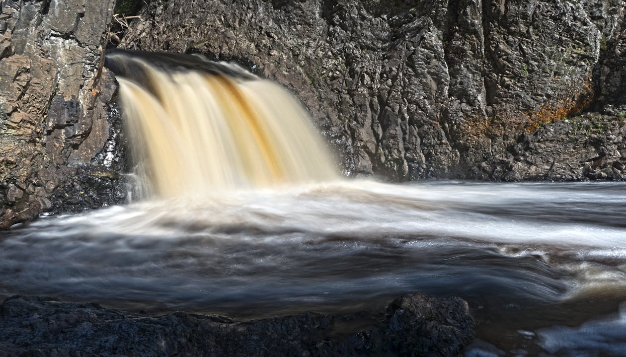 Waterfalls Cascading from Gray Rocky Cliff