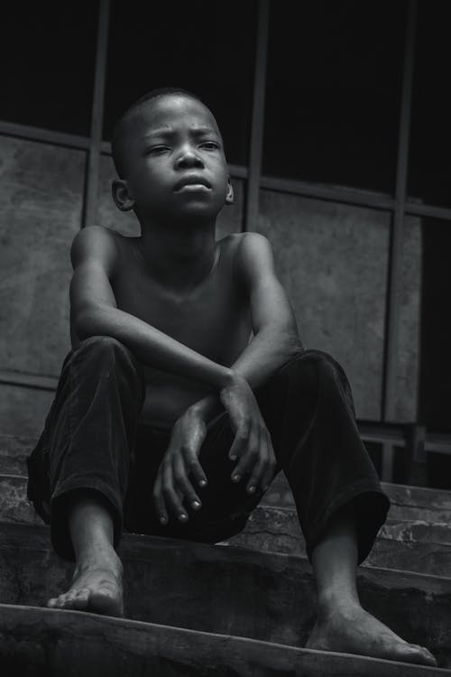 Free Closeup Photo of Boy Sits on Stairway Stock Photo