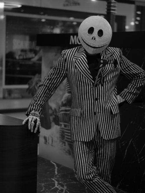 Free Person in a Jack Skellington costume with striped suit, posing indoors. Stock Photo