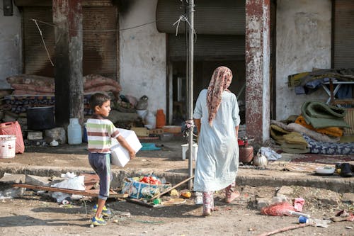 Woman and Boy on Messy Street