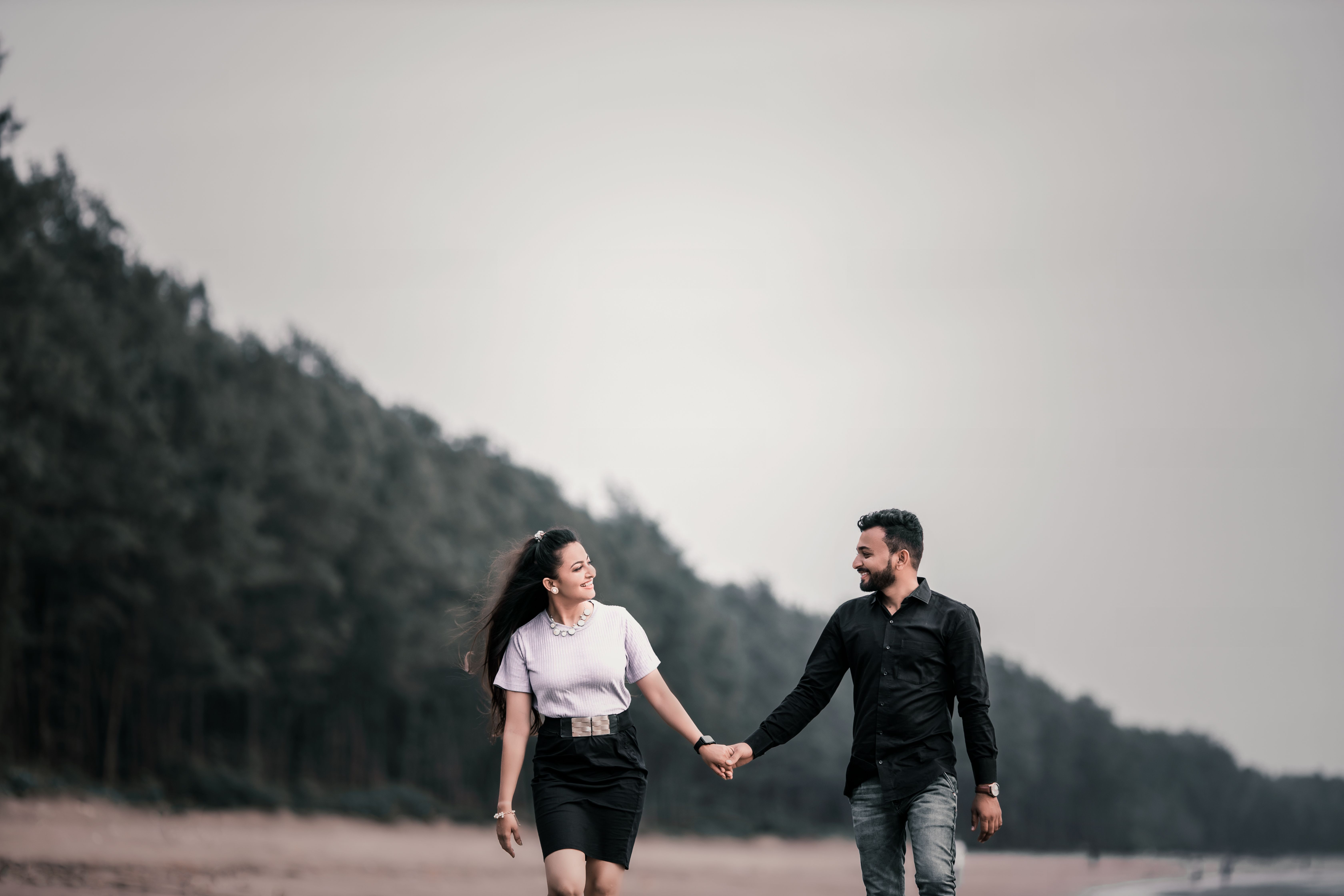 A Couple Holding Hands While Walking Outdoors · Free Stock Photo