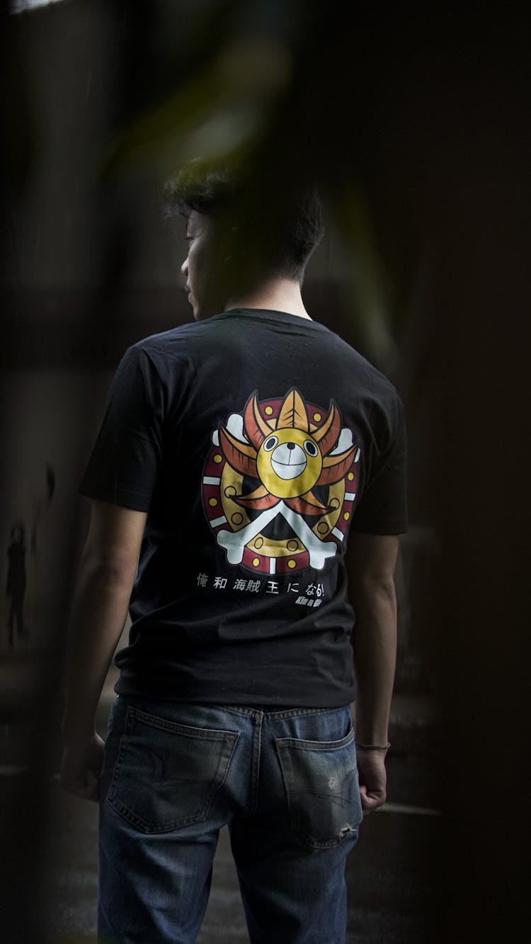 Man Wearing Black T-shirt With Cartoon Logo On Back