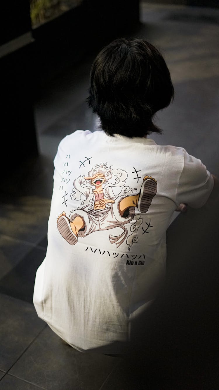 Man Wearing Shirt With Cartoon Drawing On Back