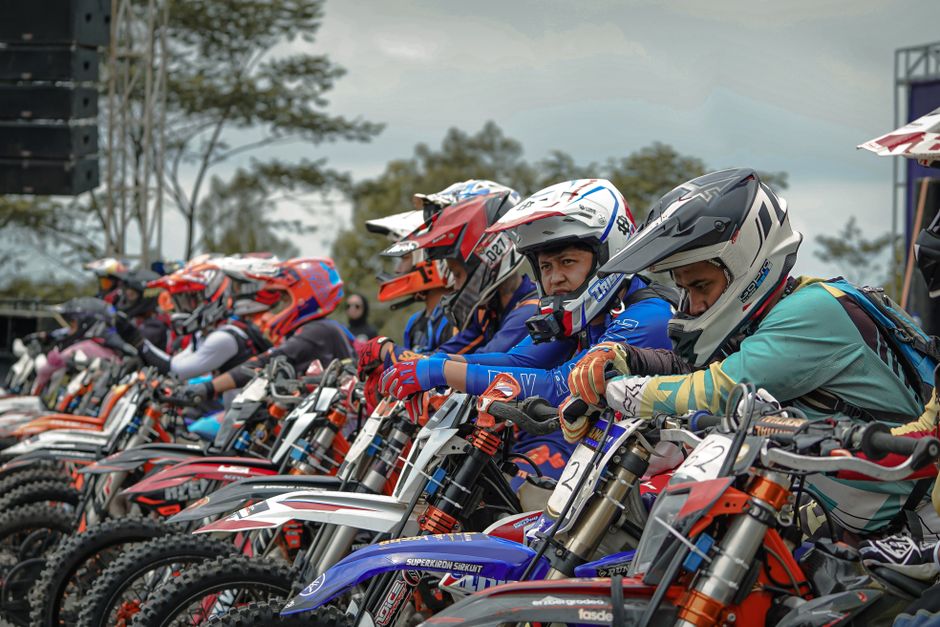 A thrilling off-road motorbike race underway at Yogyakarta, showcasing bikers in vibrant gear. A thrilling off-road motorbike race underway at Yogyakarta, showcasing bikers in vibrant gear.